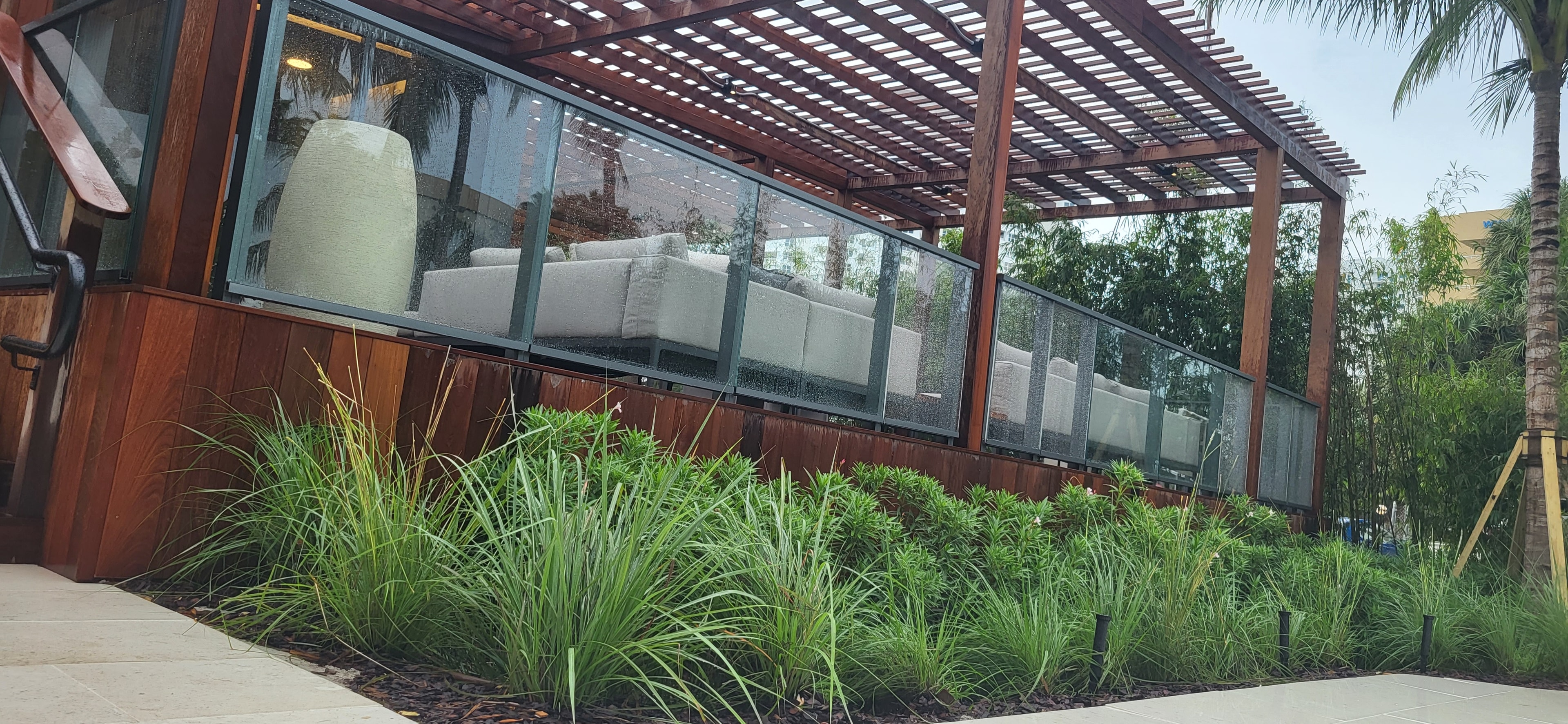 Waldorf Astoria Pompano Beach — patio with ornamental grasses and pergola